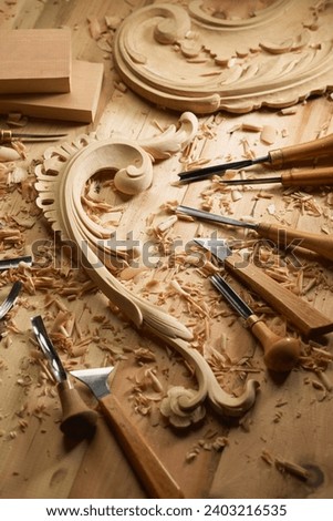 Professional tools on a wooden table in the workshop. Surface covered with sawdust. Carpenter working with tools close-up. Royalty-Free Stock Photo #2403216535