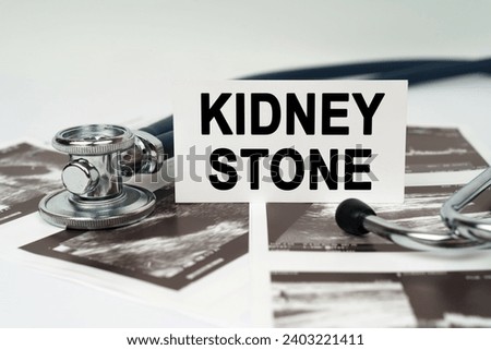 Medical concept. On the ultrasound pictures there is a stethoscope and a business card with the inscription - Kidney stone