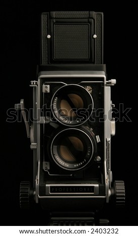 Vintage TLR medium format camera camera, front view on black