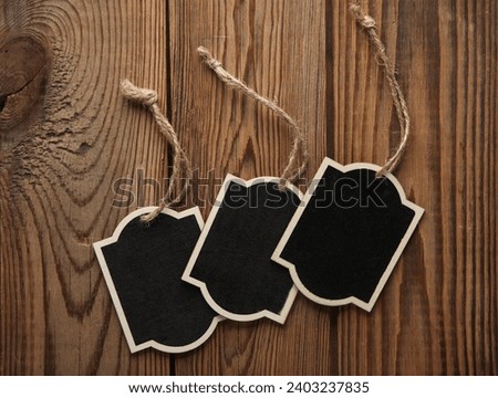 Chalkboard labels, blank wooden blackboard tags, garden sign on wooden background