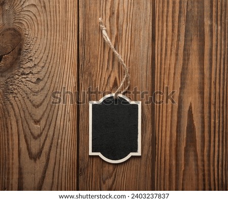 Chalkboard label, blank wooden blackboard tag, garden sign on wooden background