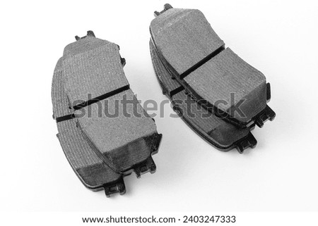 Modern new brake pads for passenger car ventilated disc brakes, brake pads close-up on white background, studio photo