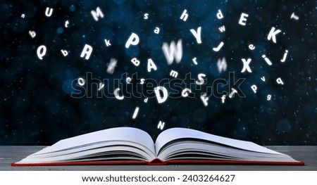 Letters flying out of open book on table, bokeh effect. Banner design