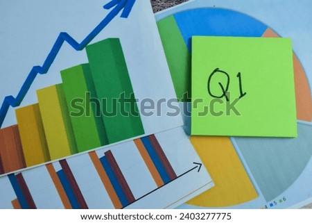 Concept of Q1 - 1st Quarter Period write on sticky notes isolated on Wooden Table. Stock market concept
