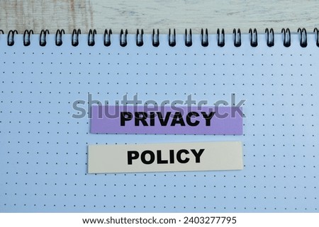 Concept of Privacy Policy write on book isolated on Wooden Table.