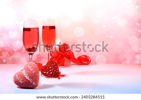 Festive alcoholic cocktail Mimosa with cranberries in glasses and love hearts, Valentine's Day concept, alcoholic drinks at a party, bar and restaurant advertising, selective focus Royalty-Free Stock Photo #2403284515