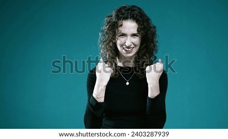 Reserved Female with Fists Pumped in Subtle Victory Celebration