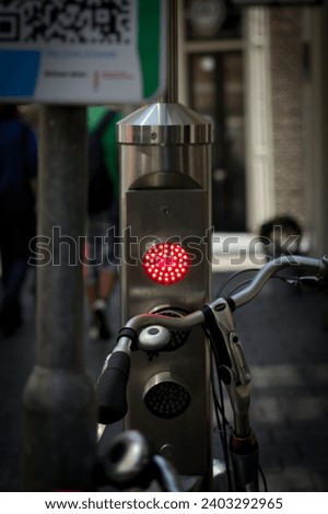 Red traffic light locking a metallic bicycle