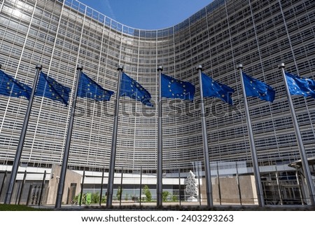 European flags in front of headquarters of European commission in Brussels in summer day Royalty-Free Stock Photo #2403293263