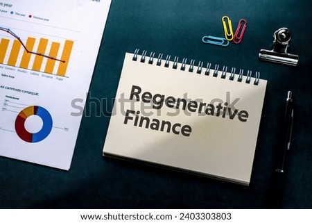 There is notebook with the word Regenerative Finance. It is as an eye-catching image.