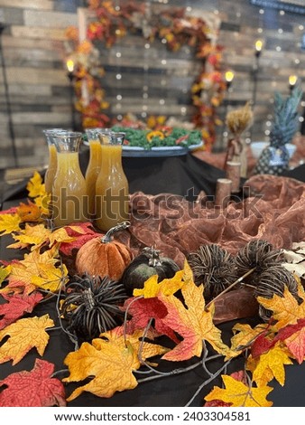 Thanksgiving dinner. Beautiful table with thanksgiving autumn decoration, bright leaves and pumpkins. Bottles of juice and food on the table. Closeup picture. Holiday concept