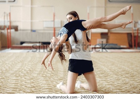 Lovely little girls gymnasts training in a athletics class