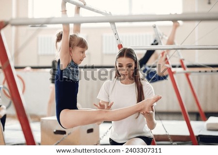 Prepare young child athlete gymnast on balance beam