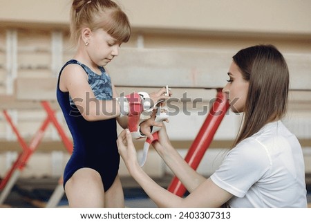 Lovely little girls gymnasts training in a athletics class