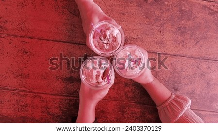 Background of hands holding ice cream in a plastic cup. Friendship concept.