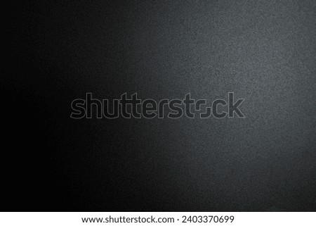 Black paper background with light for adding letters.