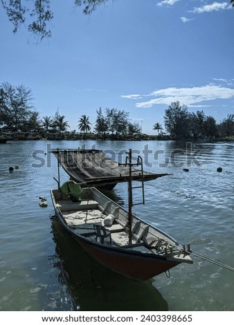 The picture shows the small fishing boats tied up at the jetty after finishing the work of catching fish in the ocean. Photo taken at noon in Terengganu, Malaysia.