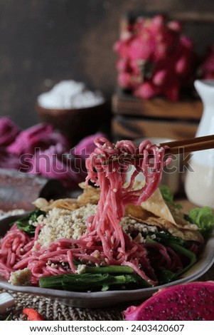 Dragon fruit noodles with chicken topping, served warm during the rainy season