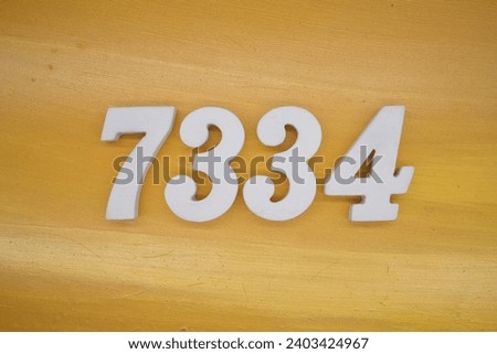 The golden yellow painted wood panel for the background, number 7334, is made from white painted wood.