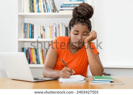 Stressed and tired black female student learning for graduation of university
