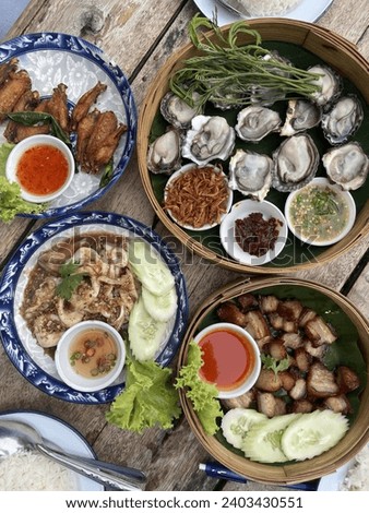 Thai foods on Bang saen beach ,Chonburi Thailand. Royalty-Free Stock Photo #2403430551