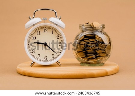 Saving coins in a glass jar Concepts of saving money and financial investment, creating income, planning finances. Cash loans and investments Home loans and time