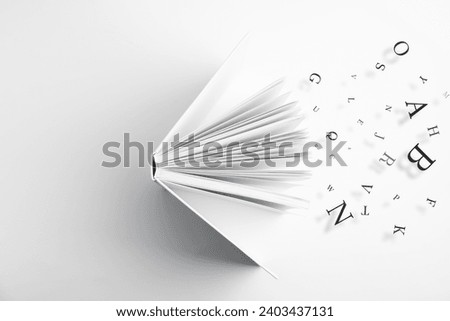 Open book with letters flying out of it on white background, top view