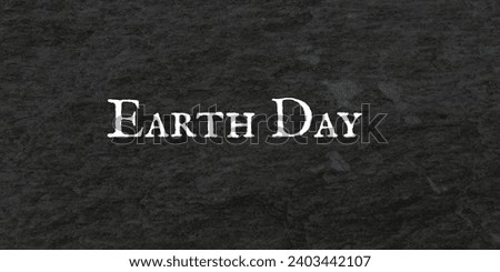 Earth day banner with stylish writing on black dark background texture of black stone.