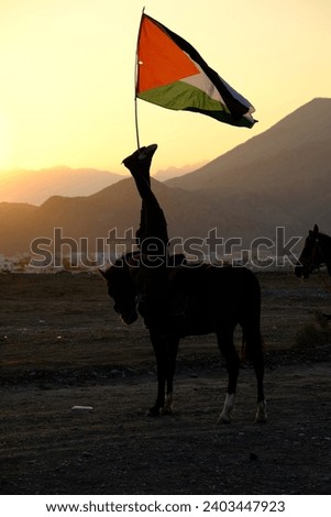 Pictures of horses in Oman, training for horse race, Arabic horse and horse show in sunset with flag of Palestina.