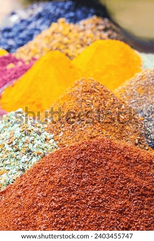 Spices Market with colourful mood. Multicolor spices sold at Egypt Bazaar (Misir Carsisi) in Istanbul, Turkey (Turkiye). Selected focus, copy space, vertical. Colorful food background