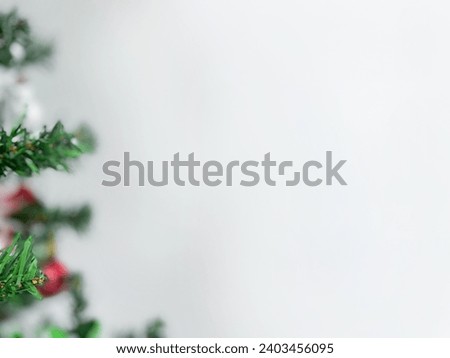 white background image with a picture of a real Christmas tree and beautiful ornate Christmas tree ornaments It is a happy festival of New Year and Christmas.