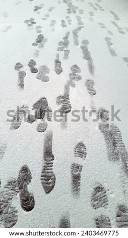 Footprints on the snowy surface. Snow cover with human footprints