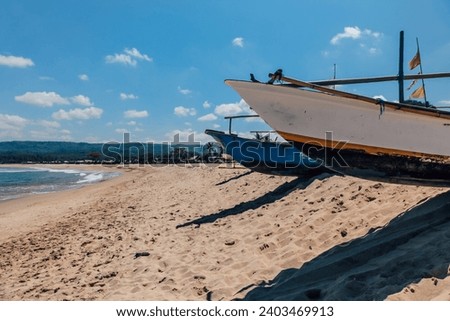 Fisherman Boat in Sawarna Beach and Sand at Clear Sky and High Wave Noon, Banten Indonesia