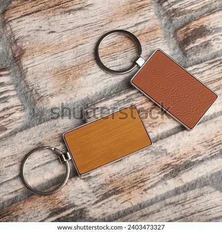 Metal and leather keychains. Colorful one side leather; Square, rectangle and circle shaped key rings. Concept shots, photos taken specially for e-commerce sales. Wall stone background.