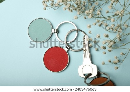Metal and leather keychains. Colorful one side leather; Square, rectangle and circle shaped key rings. Concept shots, photos taken specially for e-commerce sales. Blue background.