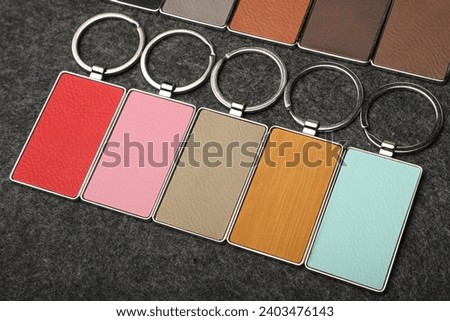 Metal and leather keychains. Colorful one side leather; Square, rectangle and circle shaped key rings. Concept shots, photos taken specially for e-commerce sales. Black fabric background