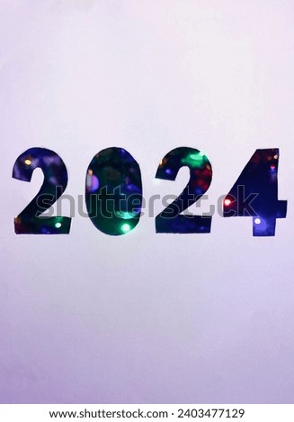 Inscription 2024 with Christmas tree decorations and garland