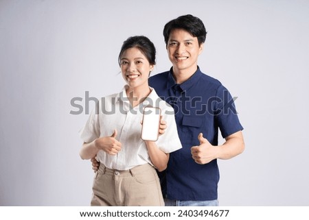 Image of an Asian couple posing on a white background