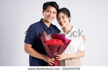 Image of an Asian couple posing on a white background