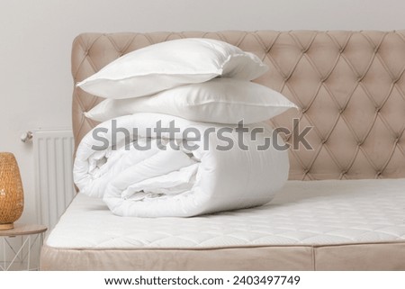 Soft folded duvet and pillows on bed
 Royalty-Free Stock Photo #2403497749