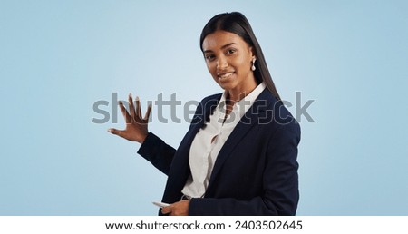 Business woman, portrait and presentation of anchor in advertising on a blue studio background. Female person or employee reporter and speaking, teaching or showing information on mockup space