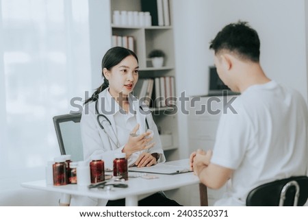 An Asian female doctor gives a pep talk to a male patient inside the hospital.