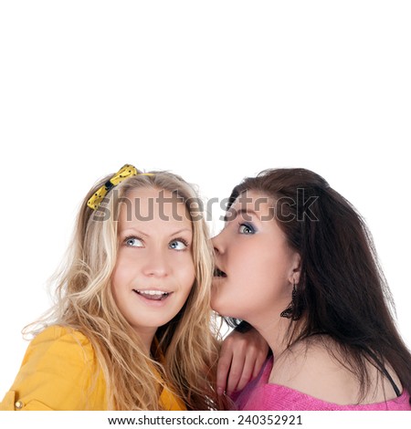 pretty young girl whispering something to her friend