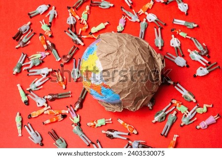 Figurines around globe as death toll. Coronavirus pandemic in world. Royalty-Free Stock Photo #2403530075