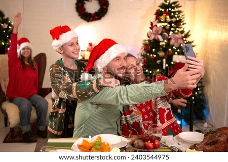 Family taking selfie at Christmas party at home