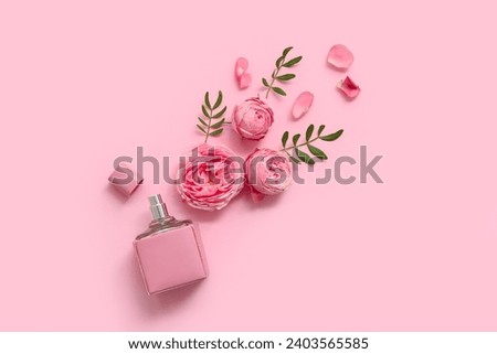 Beautiful composition with bottle of perfume and rose flowers on pink background Royalty-Free Stock Photo #2403565585