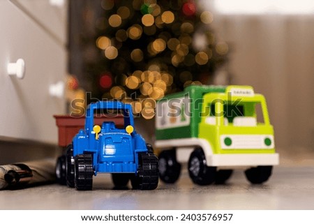 toy cars on the background of a Christmas tree in the apartment room