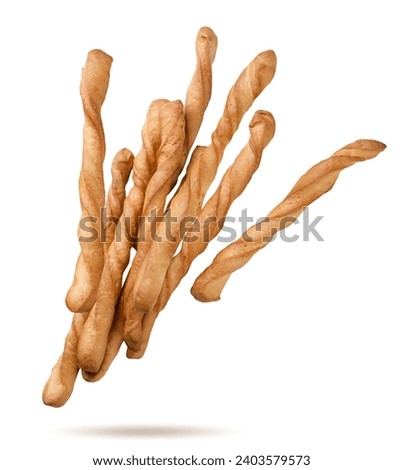 Grissini sticks flying close-up on a white background. Isolated Royalty-Free Stock Photo #2403579573