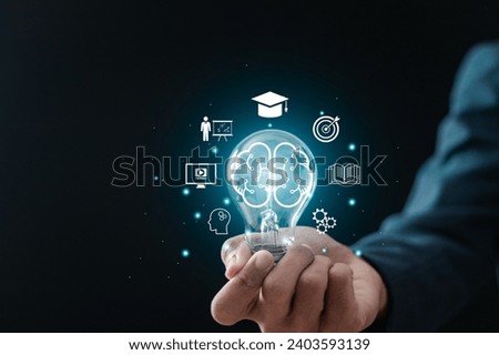 E-learning concept, businessman holding light bulb with brain and e-learning icons for learning and personal development. Digital courses to develop new skills.