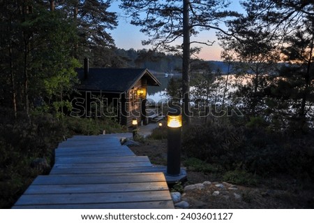 Traditional Finnish summer sauna and handmade wooden stairs in the archipelago  Royalty-Free Stock Photo #2403601127